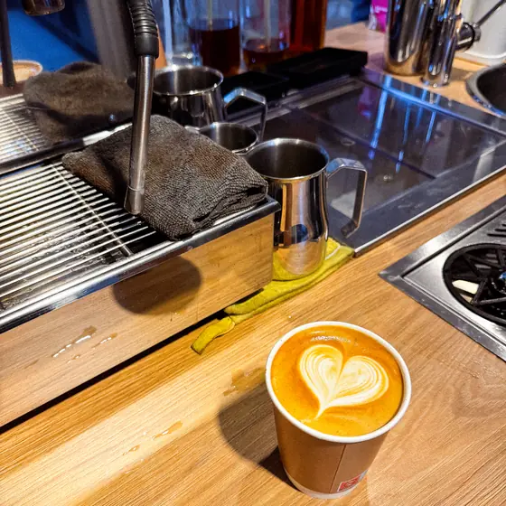 Latte art in a takeaway cup on the counter