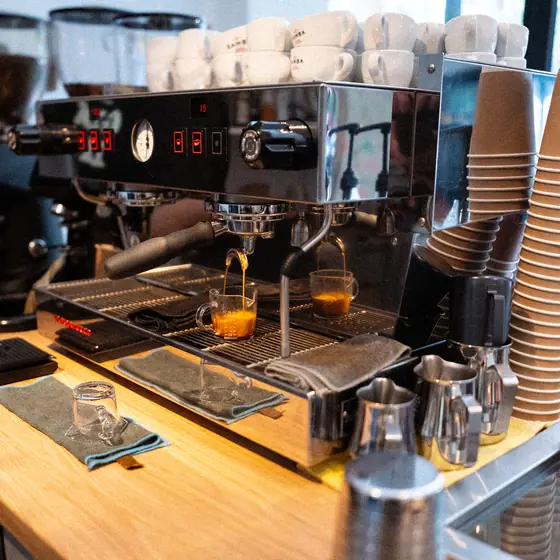 The espresso machine, cups stacked on top