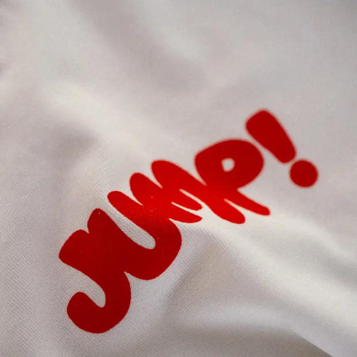 The Jump! wordmark printed in red across the chest